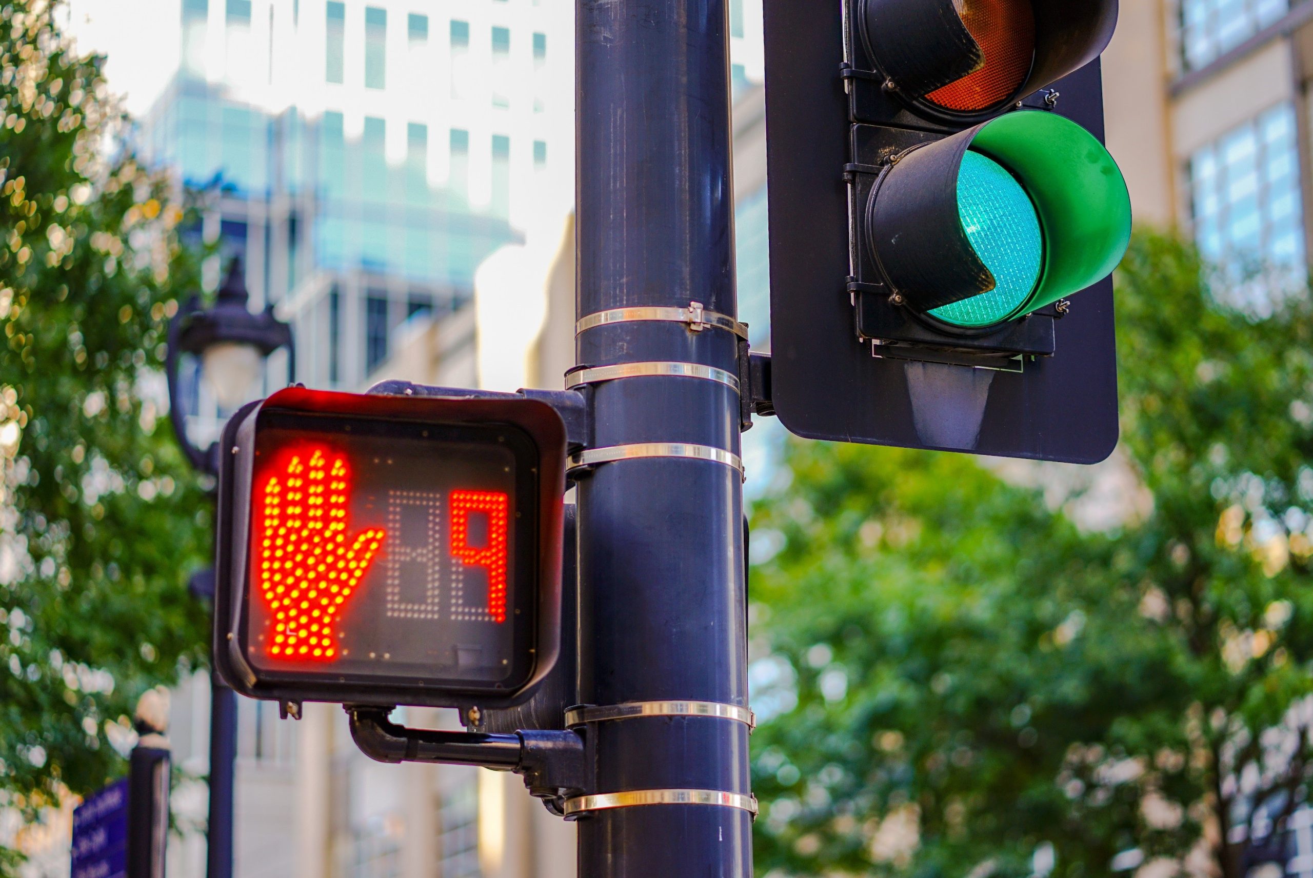 Right of way crosswalk sign with red hand for stop